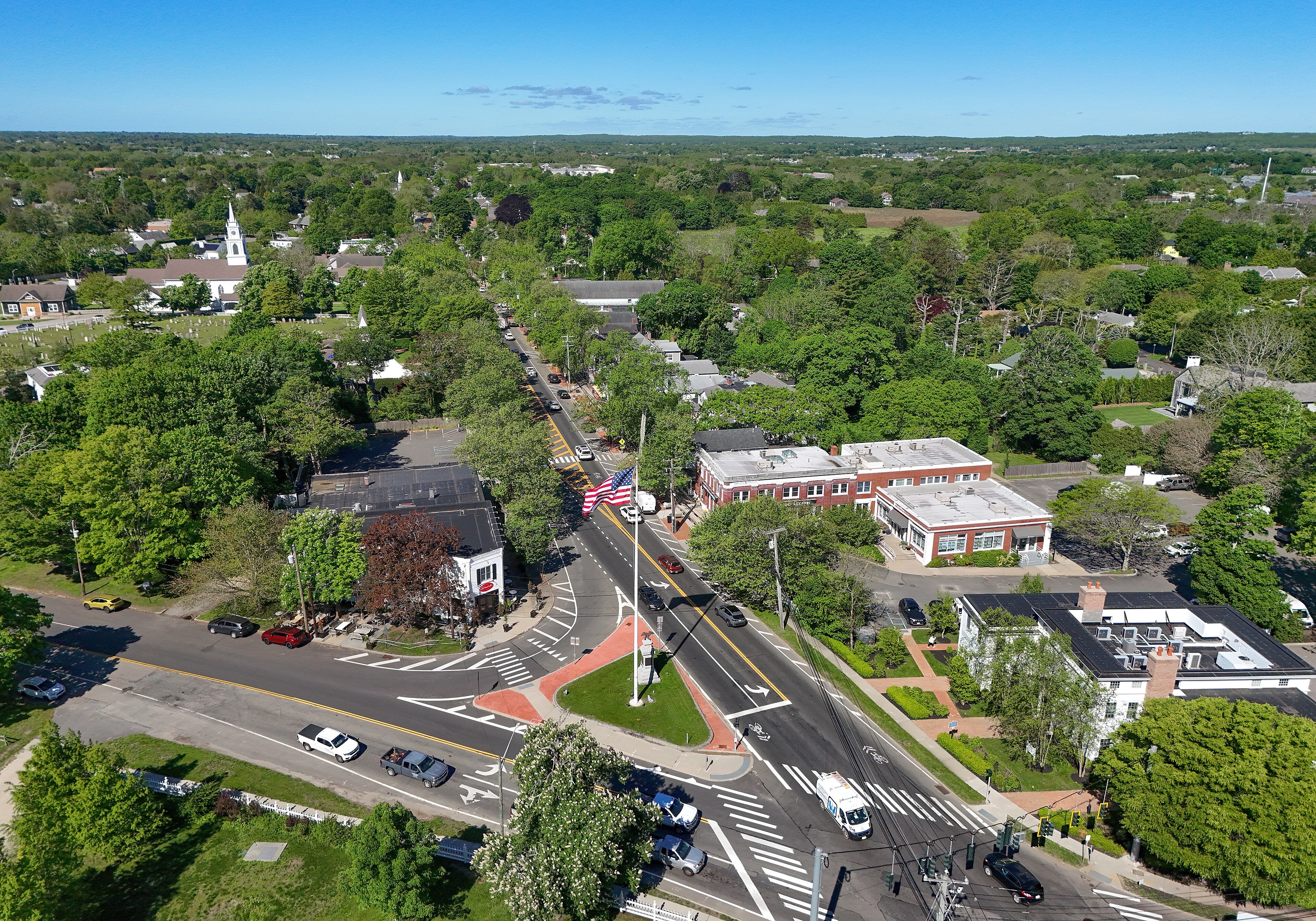 An aerial view of Bridgehampton village surrounded by trees and open land