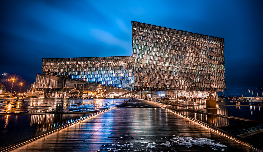The glass facade of Harpa concert hall in Reykjavik reflects soft northern light