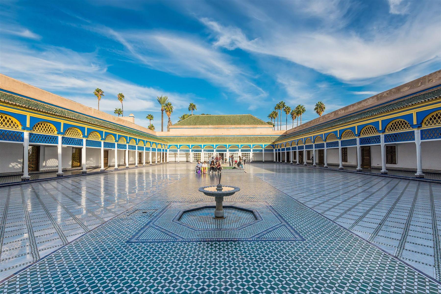 The tiled courtyard of Bahia Palace in Marrakech opens beneath a wide blue sky