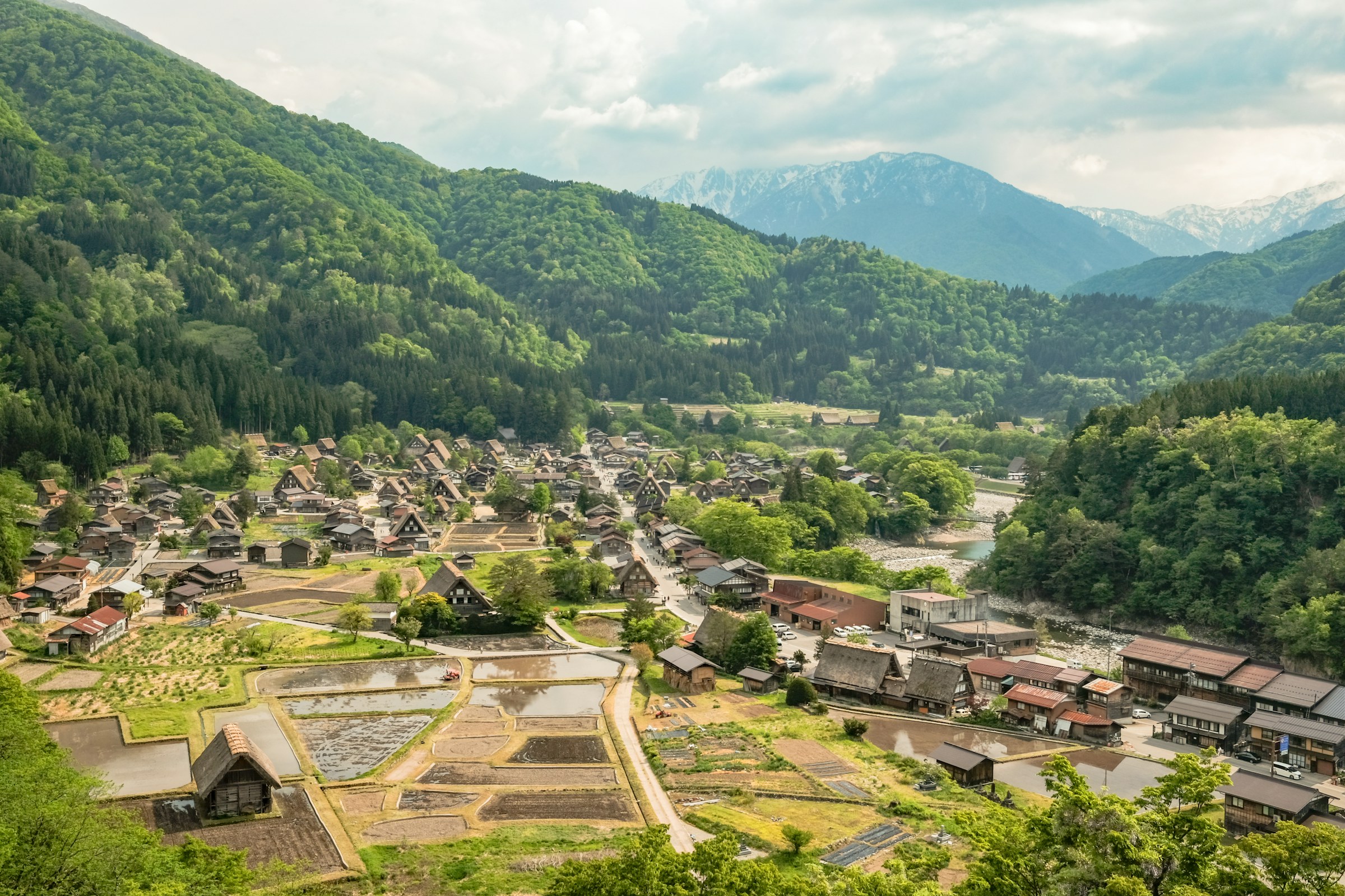 A quiet mountain village and rice fields surrounded by green Japanese mountains
