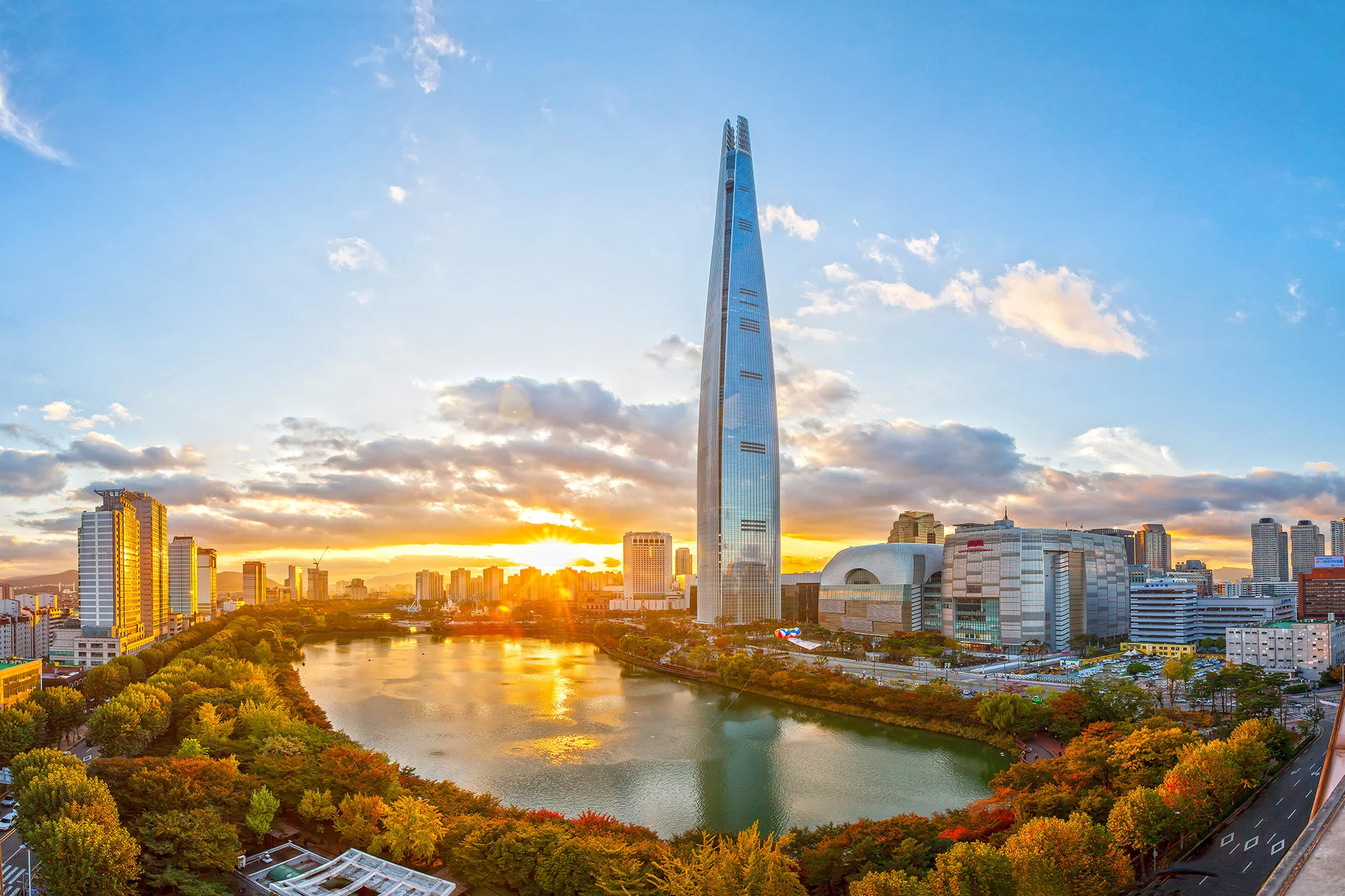 LOTTE World Tower and Seokchon Lake at sunset in Jamsil, home to SIGNIEL Seoul
