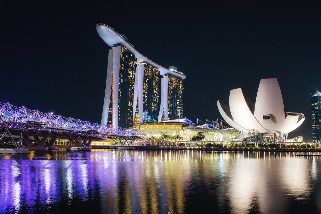 Marina Bay Sands and the Singapore skyline reflected in the water at dusk