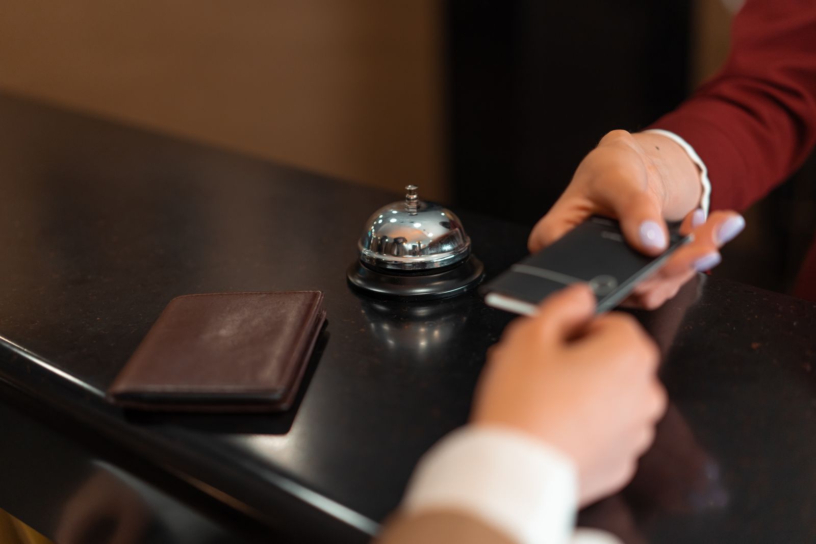 A traveler checks in with a hotel receptionist
