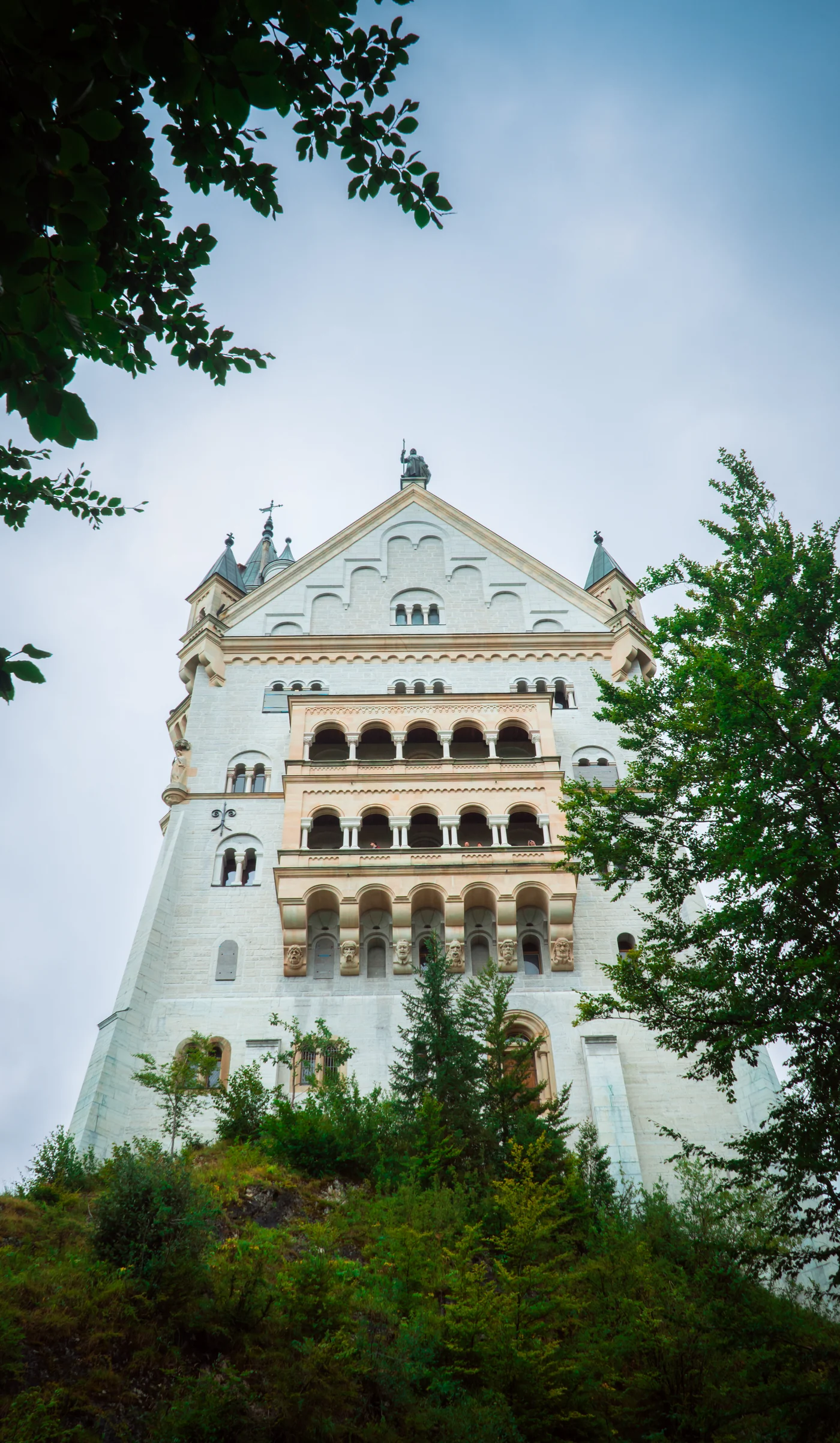 Neuschwanstein Castle rising above trees in Bavaria, Germany